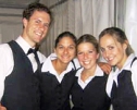 Four happy catering servers